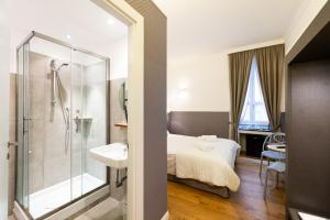 a bathroom with a bed and a shower and a sink at Magenta Collection Sant'Anna in Rome