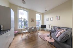 a living room with a couch and a table at Apartment 1 Isabella House, Aparthotel, By RentMyHouse in Hereford