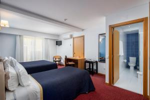 Postel nebo postele na pokoji v ubytování Stay Hotel Leiria Centro