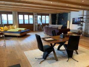 a living room with a table and a couch at Haus Rhätikon Mayer in Davos