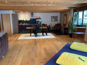 a living room with a table and a couch at Haus Rhätikon Mayer in Davos