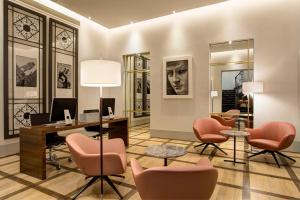 an office with pink chairs and a desk with a computer at Hotel Orto de' Medici in Florence