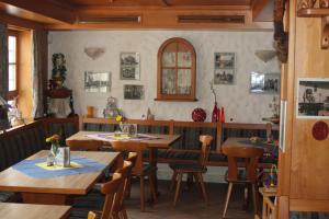 a dining room with wooden tables and chairs at Restaurant / Pension Mainzer Tor in Alsfeld