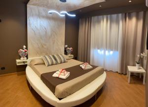 a bedroom with a bed and a dresser at TH LUXURY fly in Catania