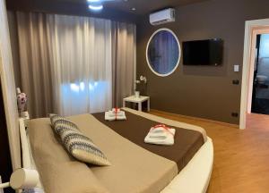 1 dormitorio con 1 cama y TV en la pared en TH LUXURY fly en Catania