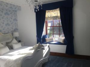 
a bedroom with a bed and a window at Glenspean Lodge Hotel in Roybridge
