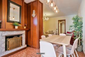 a dining room with a table and a fireplace at Alcam Barbera Centro in Barbera del Valles