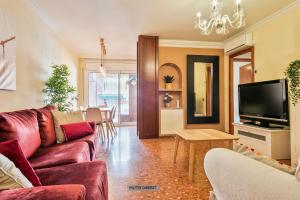 a living room with a couch and a tv and a table at Alcam Barbera Centro in Barbera del Valles