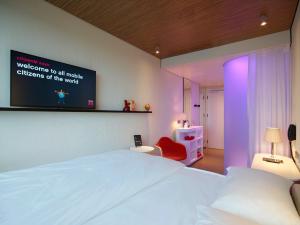 a hotel room with a bed and a desk at citizenM Glasgow in Glasgow