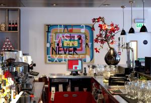 
a kitchen filled with lots of clutter and decorations at citizenM Glasgow in Glasgow
