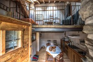 a large room with a table and a balcony at B&B LA VILLE CHAMOIS in Chamois