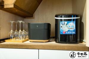 a coffee maker sitting on a counter next to wine glasses at Konjaku-So Bentencho Osaka Bay -Universal Bay Area- in Osaka