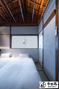 Posteľ alebo postele v izbe v ubytovaní Konjaku-So Bentencho Osaka Bay -Universal Bay Area-