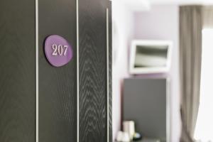 a door with a purple number on it at Golden Hotel in Naples