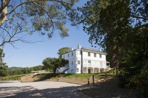 a large white house on top of a hill at The Westgate in Charmouth