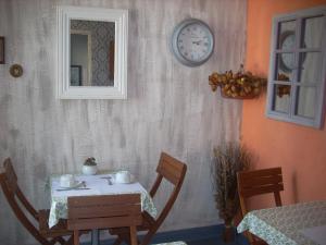a dining room with a table and a clock on the wall at Hotel du Château in Nantes