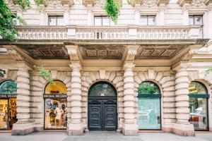 a building with a black door on a street at Enzo Capo Andrassy Avenue in Budapest