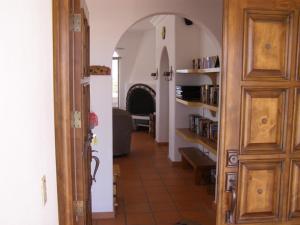 a hallway leading to a living room with an archway at Casa Las Vistas del Mar by FMI Rentals in Puerto Peñasco