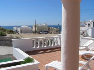 a balcony with chairs and a view of the ocean at Casa Las Vistas del Mar by FMI Rentals in Puerto Peñasco