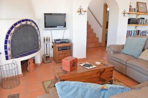 a living room with a couch and a tv at Casa Las Vistas del Mar by FMI Rentals in Puerto Peñasco