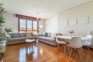 a living room with a couch and a table at Amplio y Luminoso sobre la Ría de Barakaldo in Barakaldo