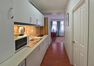a kitchen with white cabinets and a sink at Duru Istanbul Apart in Istanbul