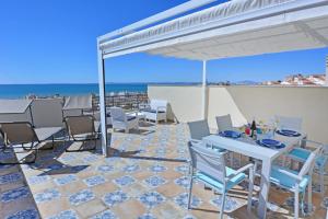 a patio with a table and chairs and the ocean at Penthouse with Panoramic View by NRAS in Santa Pola +21 photos