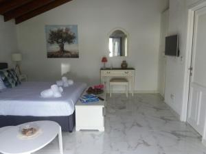 a hotel room with a bed and a table and a table sidx sidx at VILLA TELLINA in Skiathos