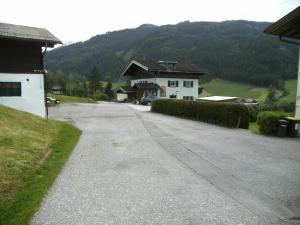 eine leere Straße mit einem Haus und einem Berg in der Unterkunft Gästehaus Zum Tauern in Radstadt