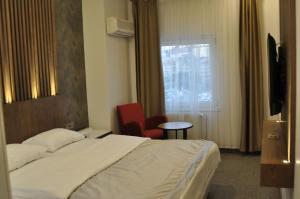 a hotel room with a bed and a window at ADMİRAL in Kayseri