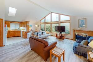 ein Wohnzimmer mit einem Sofa und einem TV in der Unterkunft Captain Bill's Beachhouse in Lincoln City