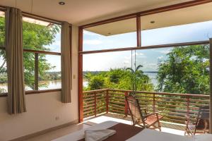 a room with a balcony with a view of the ocean at Wasai Puerto Maldonado Eco Lodge in Puerto Maldonado