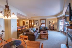 a living room with a couch and a table at Comfortable 1 Bedroom Condo - Slopeside condo in Crested Butte