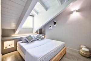 a bedroom with a large bed in a attic at ACADAMIS - Suites & Junior Suites in Turin