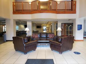 a living room with two couches and a couch at Wingate by Wyndham Coon Rapids in Coon Rapids