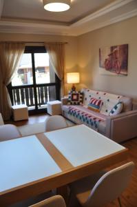 a living room with a couch and a table at Apartamento Florido Centro Gramado in Gramado