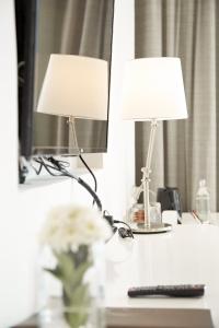 two lamps sitting on a desk in front of a mirror at Centara Q Resort Rayong in Mae Pim