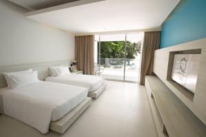 Postel nebo postele na pokoji v ubytování Centara Q Resort Rayong