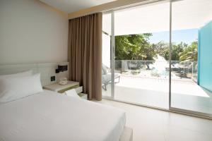 Postel nebo postele na pokoji v ubytování Centara Q Resort Rayong
