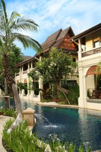 a swimming pool in front of a house at Khum Phaya Resort & Spa Boutique Collection in Chiang Mai