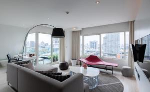 a living room with a couch and a table at Centara Watergate Pavilion Hotel Bangkok in Bangkok