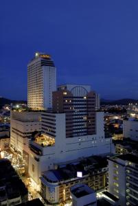 a city lit up at night with tall buildings at Centara Hotel Hat Yai in Hat Yai