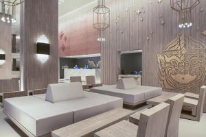 a room with two white couches and a table at Centara Life Phu Pano Krabi-SHA Plus in Ao Nang Beach