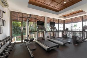 a gym with treadmills and chairs in a room at Centara Villas Samui in Lamai