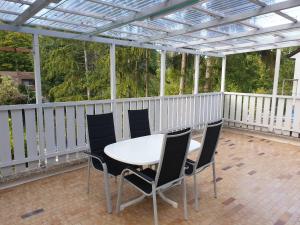 a patio with a table and chairs on a deck at Apartment Ferienhaus in Würzburg