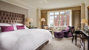 a bedroom with a large white bed and purple accents at InterContinental Dublin, an IHG Hotel in Dublin
