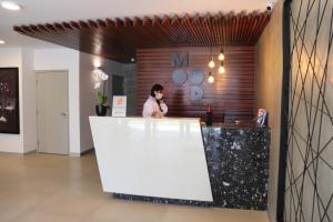 a man standing at a counter in a restaurant at Cayma Apart's IV Miraflores-Barranco in Lima