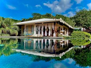 a house with its reflection in the water at Magic Mountain Views Villa in Atenas