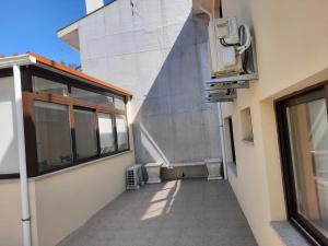 an empty hallway of a building with a window at Maia Oporto Suites in Maia +4 photos