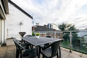 a table and chairs on the balcony of a house at Central City Villa in Neuss